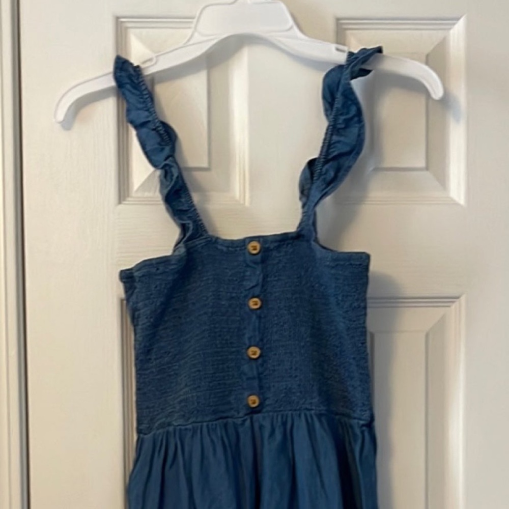 Denim sundress with ruffle straps and hem.  Top is elastic smocking. Size small